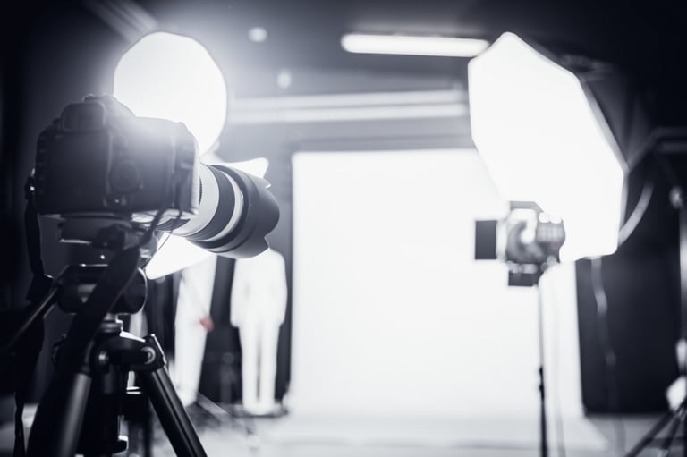 Large photo studio with professional lighting equipment and camera on tripod